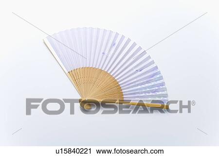 Stock Image - Japanese folding fan, high angle view, white background. Fotosearch