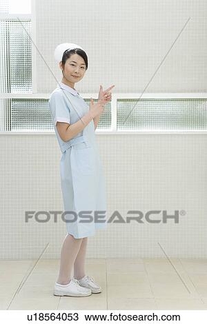 Portrait of a nurse, smiling and looking at camera, side view View Large Photo Image Stock Image - Portrait of a nurse, smiling and looking at camera, side view. Fotosearch