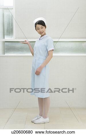 Portrait of a nurse, smiling and looking at camera, side view View Large Photo Image Stock Image - Portrait of a nurse, smiling and looking at camera, side view. Fotosearch