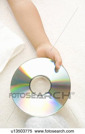 Baby holding CD View Large Photo Image Stock Photography - Baby holding CD. Fotosearch