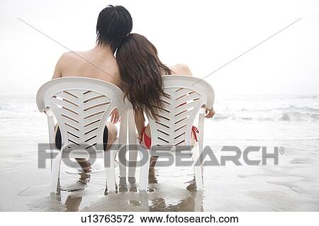 Stock Image - Back of couple in swimsuits. Fotosearch