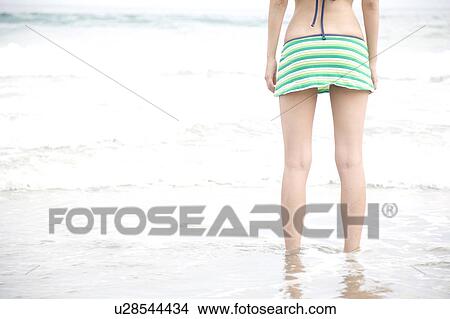 Picture - Back of woman in swimsuit. Fotosearch