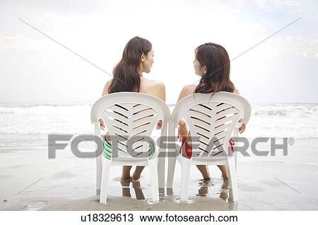 Stock Image - Back of women in swimsuits. Fotosearch