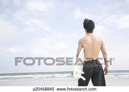 Stock Image - Back view of young man. Fotosearch