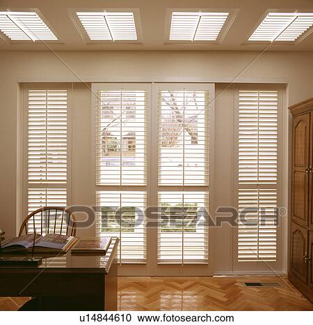 Stock Image - Blinds over windows in an office. Fotosearch