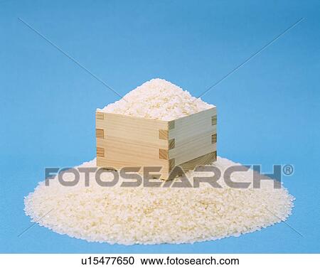 Stock Image - Box of rice with a blue background. Fotosearch