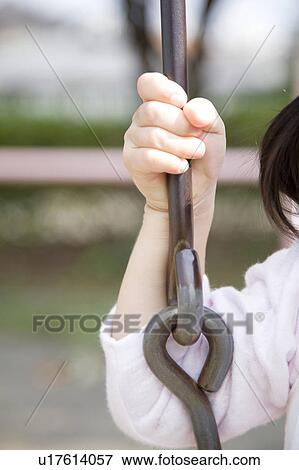 Stock Photo - Childs hand gripping a chain on swing. Fotosearch