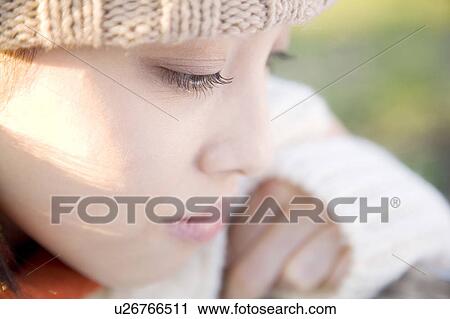 Stock Image - Close-up of young woman's face. Fotosearch