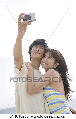 Stock Photo - Couple shooting photo. Fotosearch