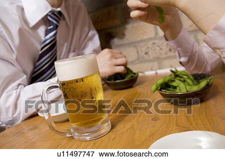 Stock Photo - Coworkers having a beer. Fotosearch