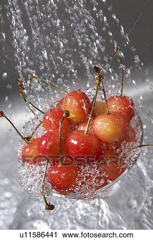 Stock Image - Cup of Cherries being washed. Fotosearch