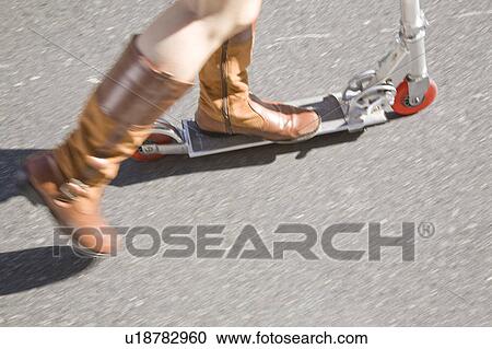 Foot of woman riding a kick scooter View Large Photo Image Stock Image - Foot of woman riding a kick scooter. Fotosearch
