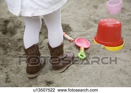 Girl playing in a sandbox View Large Photo Image Stock Image - Girl playing in a sandbox. Fotosearch