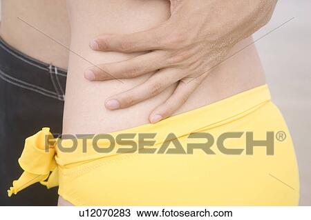 Stock Image - Hand holding lover's waist. Fotosearch