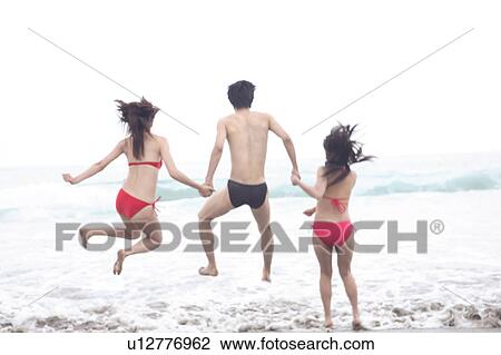 Jumping in the waves View Large Photo Image Stock Image - Jumping in the waves. Fotosearch