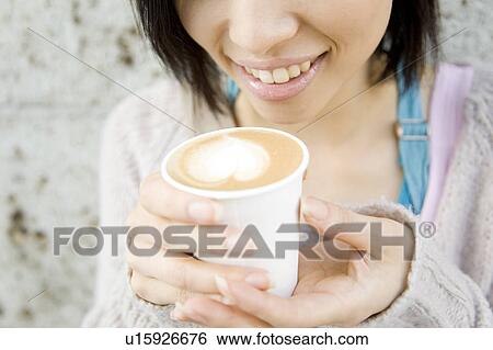 Stock Photograph - Lips of a woman drinking Cafe latte. Fotosearch