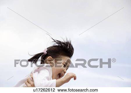 Little girl laughing and being tossed in the air outside View Large Photo Image Stock Image - Little girl laughing and being tossed in the air outside. Fotosearch