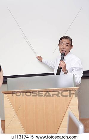 Stock Photography - Man giving a presentation. Fotosearch