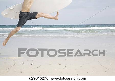Man jumping on beach View Large Photo Image Stock Photograph - Man jumping on beach. Fotosearch
