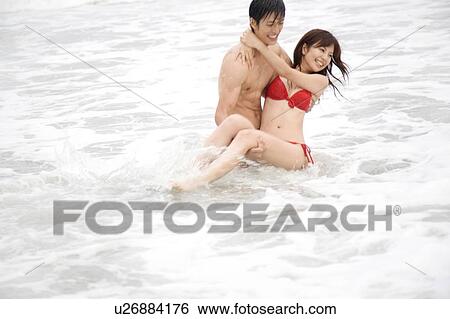 Stock Photograph - Man lifting up lover. Fotosearch
