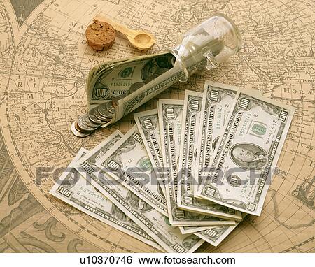 Stock Photograph - Money on an ancient map. Fotosearch