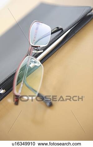 Notebook and glasses View Large Photo Image Stock Image - Notebook and glasses. Fotosearch