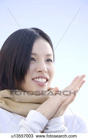 Outdoors portrait of a young woman wearing a scarf View Large Photo Image Stock Image - Outdoors portrait of a young woman wearing a scarf. Fotosearch