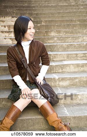 Portrait of smiling young woman on steps View Large Photo Image Stock Photo - Portrait of smiling young woman on steps. Fotosearch