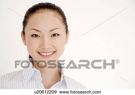 Stock Photo - Portrait of smiling young woman wearing a collared shirt. Fotosearch