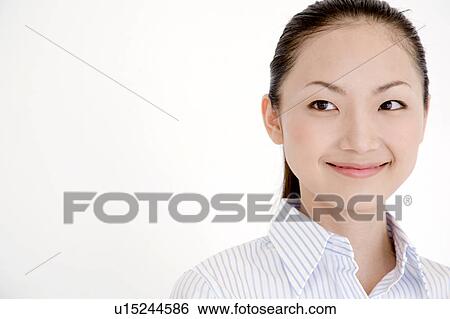 Stock Photograph - Portrait of smiling young woman wearing a collared shirt. Fotosearch