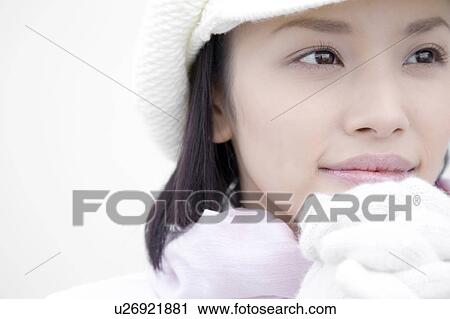 Stock Image - Portrait of woman wearing hat and gloves. Fotosearch