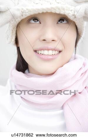 Stock Image - Portrait of woman wearing hat, gloves, and scarf. Fotosearch