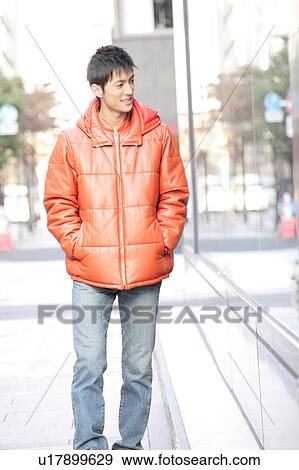Stock Photo - Portrait of young man in a winter jacket. Fotosearch