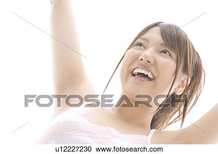 Stock Image - Portrait of young woman laughing. Fotosearch