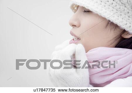 Stock Photography - Portrait of young woman with eyes closed. Fotosearch