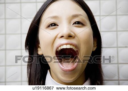 Stock Photo - Portrait of young woman yelling. Fotosearch