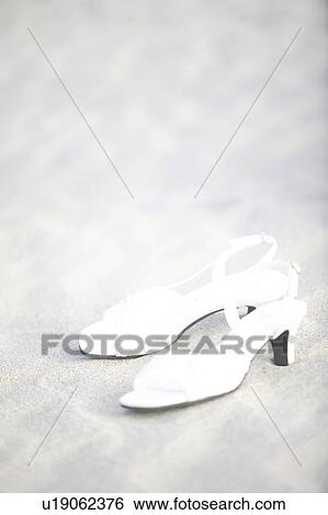 Stock Photograph - Sandals left on a beach. Fotosearch
