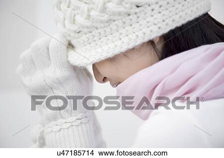 Side view of a woman wearing a hat, scarf, and gloves View Large Photo Image Picture - Side view of a woman wearing a hat, scarf, and gloves. Fotosearch