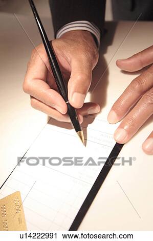 Stock Image - Signing a credit card receipt. Fotosearch