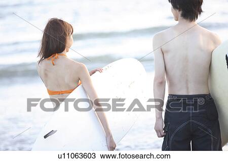 Stock Image - Surfer at Enoshima beach. Fotosearch