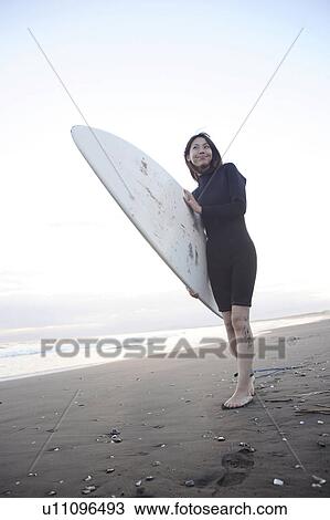 Stock Image - Surfer at Enoshima beach. Fotosearch