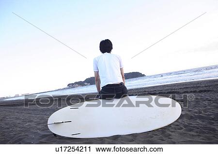 Stock Image - Surfer at Enoshima beach. Fotosearch