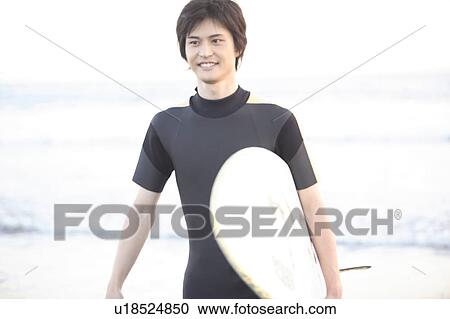 Stock Image - Surfer at Enoshima beach. Fotosearch