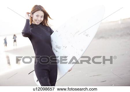 Stock Photo - Surfer at Enoshima beach. Fotosearch