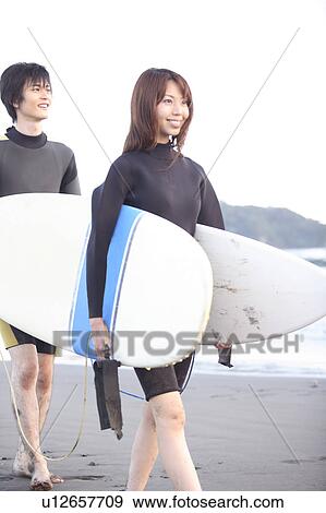 Stock Photo - Surfers at Enoshima beach. Fotosearch