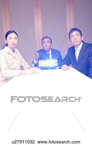 Stock Image - Three business people in a meeting. Fotosearch