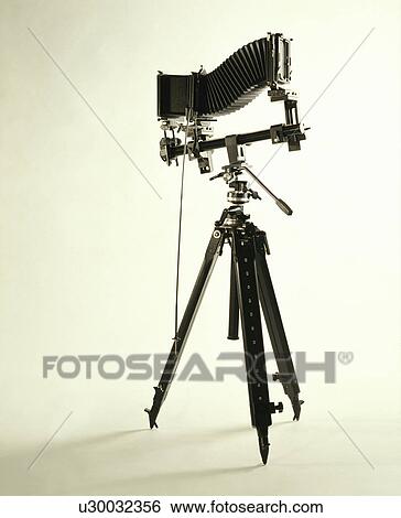 Stock Photograph - Vintage camera on a tripod. Fotosearch