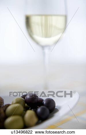 Stock Image - White wine and olives. Fotosearch