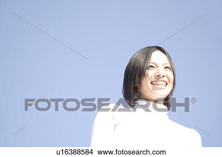Picture - Woman below the blue sky. Fotosearch