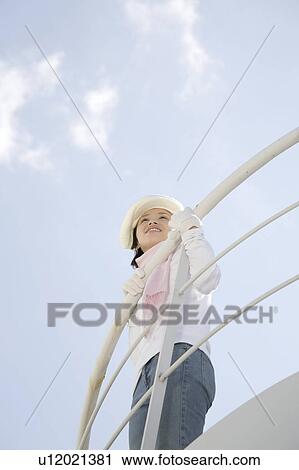 Stock Image - Woman below the blue sky. Fotosearch